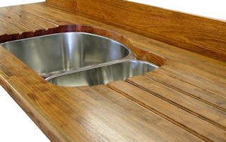 Mesquite edge grain countertop with an integrated sloping drainboard for an undermount sink.