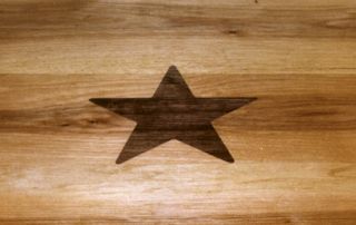Custom Walnut Star Inlay in a Face Grain Texas Pecan table top.