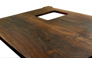 Custom wood island top made from two book-matched walnut slabs.  Rectangular shape with dog-ear corners.  Finished with tung-oil/citrus solvent.