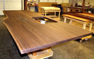 Kitchen island top with one wane edge.  Made using two walnut slabs from the same tree.  This top is in the process of being finished with tung-oil/Citrus solvent.