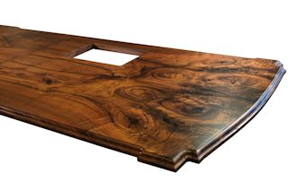 Island top constructed from two sets of book-matched Walnut slab pieces.  This top has a roman ogee edge profile and waterlox satin finish.