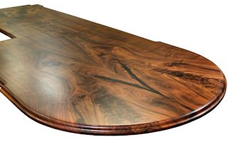 Island top constructed from two sets of book-matched Walnut slab pieces.  This top has a roman ogee edge profile and waterlox satin finish.