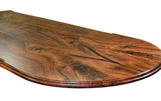 Island top constructed from two sets of book-matched Walnut slab pieces.  This top has a roman ogee edge profile and waterlox satin finish.