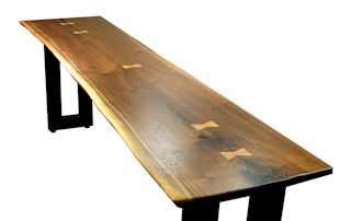Custom Walnut slab table top with maple butterfly inlays. Natural edges and Waterlox satin finish