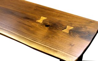 Custom Walnut slab table top with maple butterfly inlays. Natural edges and Waterlox satin finish