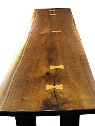 Custom Walnut slab table top with maple butterfly inlays. Natural edges and Waterlox satin finish