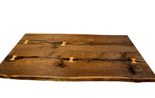 Custom Walnut slab table top with maple butterfly inlays. Constructed from one long slab cut into two sections and joined together for a book-matched appearance.  Natural edges and Tung Oil/Citrus finish