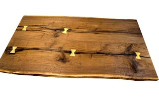 Custom Walnut slab table top with maple butterfly inlays. Constructed from one long slab cut into two sections and joined together for a book-matched appearance.  Natural edges and Tung Oil/Citrus finish