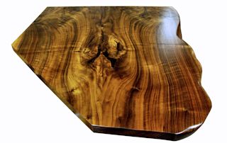 One section of a multi-section walnut slab bar top.  Using book-matched slabs with a sculpted wane edge and waterlox semi-gloss finish.