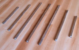Edge Grain Hard Maple Island Top with Integrated Trivet made using Stainless Steel Bars.