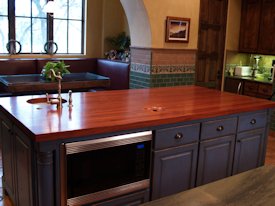 Jatoba edge grain custom wood island countertop with hand carved trash cover.