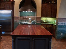 Jatoba edge grain custom wood island countertop with hand carved trash cover.