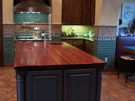 Jatoba edge grain custom wood island countertop with hand carved trash cover.