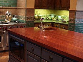 Jatoba edge grain custom wood island countertop with hand carved trash cover.