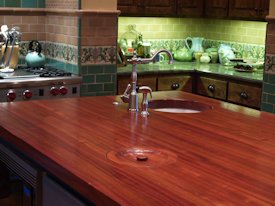 Jatoba edge grain custom wood island countertop with hand carved trash cover.