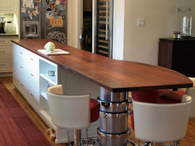 Jatoba face grain island countertop with Tung Oil Citrus finish.  Custom metal base designed by DeVos Custom Woodworking.