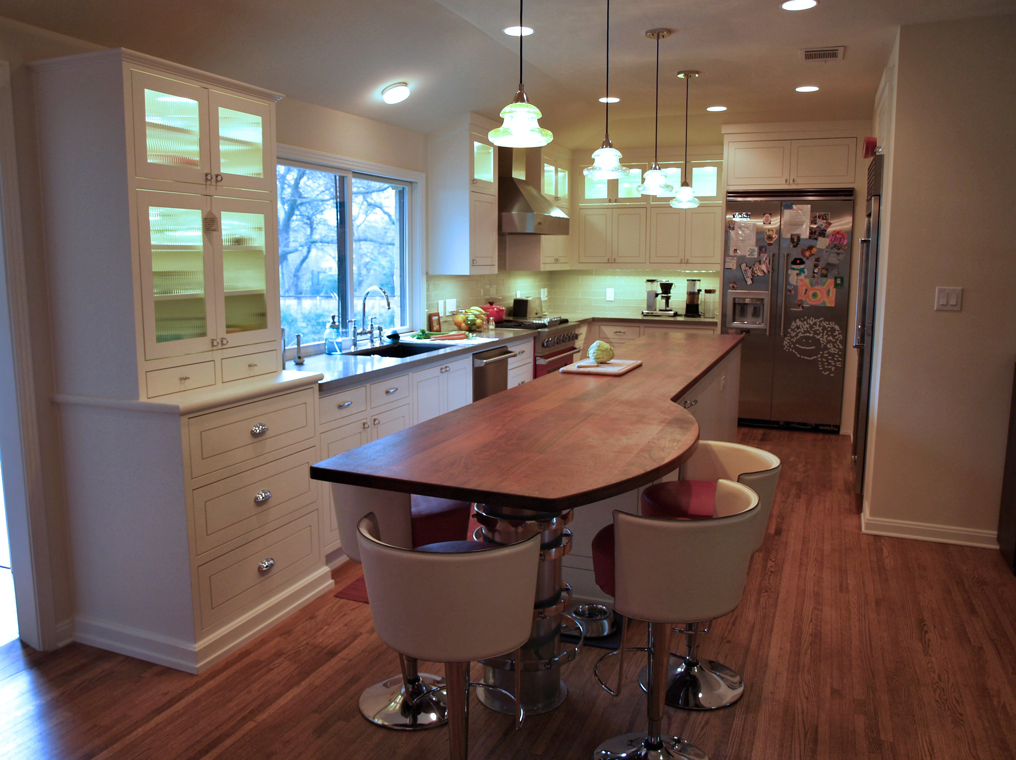 Jatoba face grain island countertop with Tung Oil Citrus finish.  Custom metal base designed by DeVos Custom Woodworking.