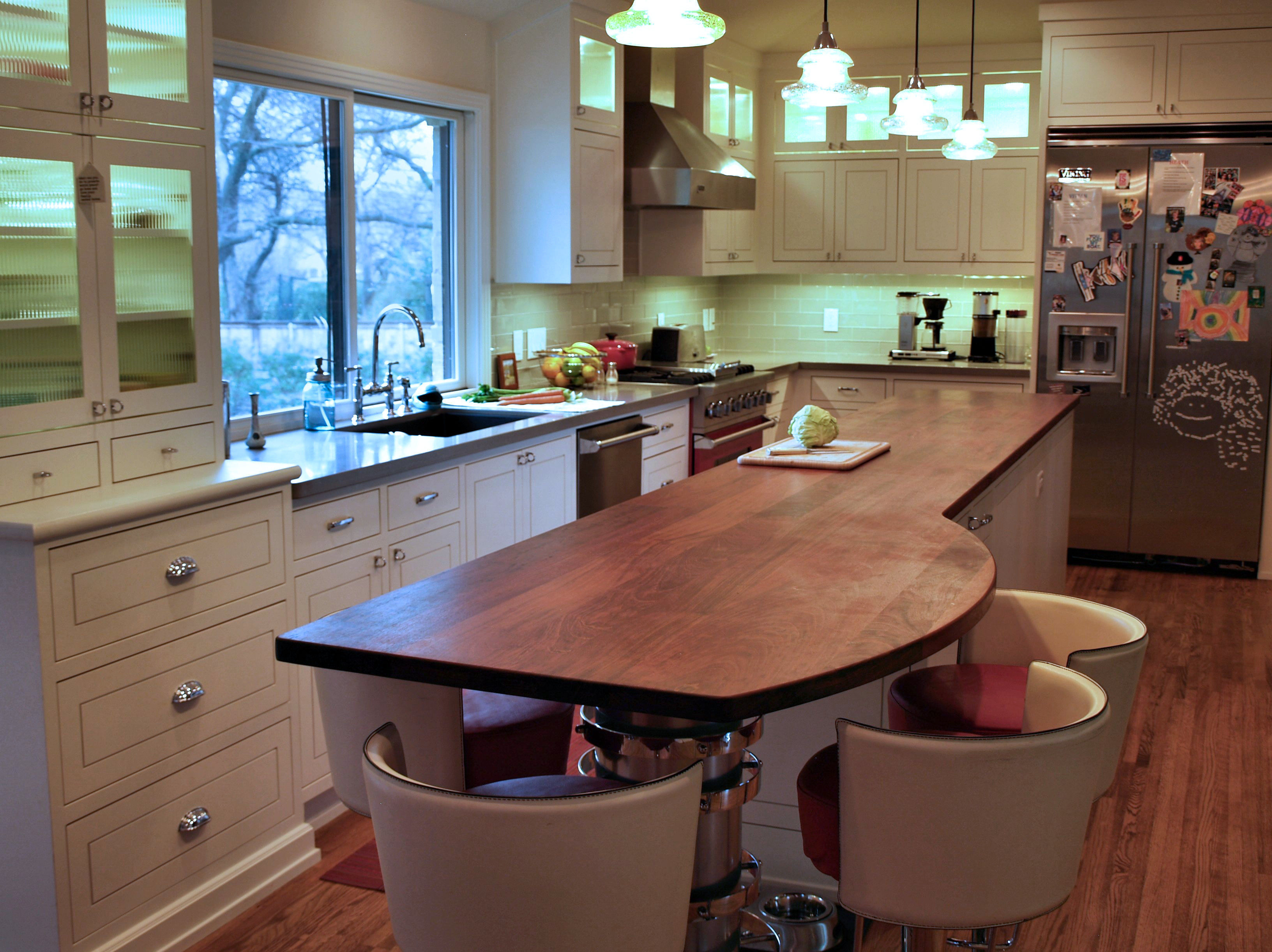 Jatoba face grain island countertop with Tung Oil Citrus finish.  Custom metal base designed by DeVos Custom Woodworking.