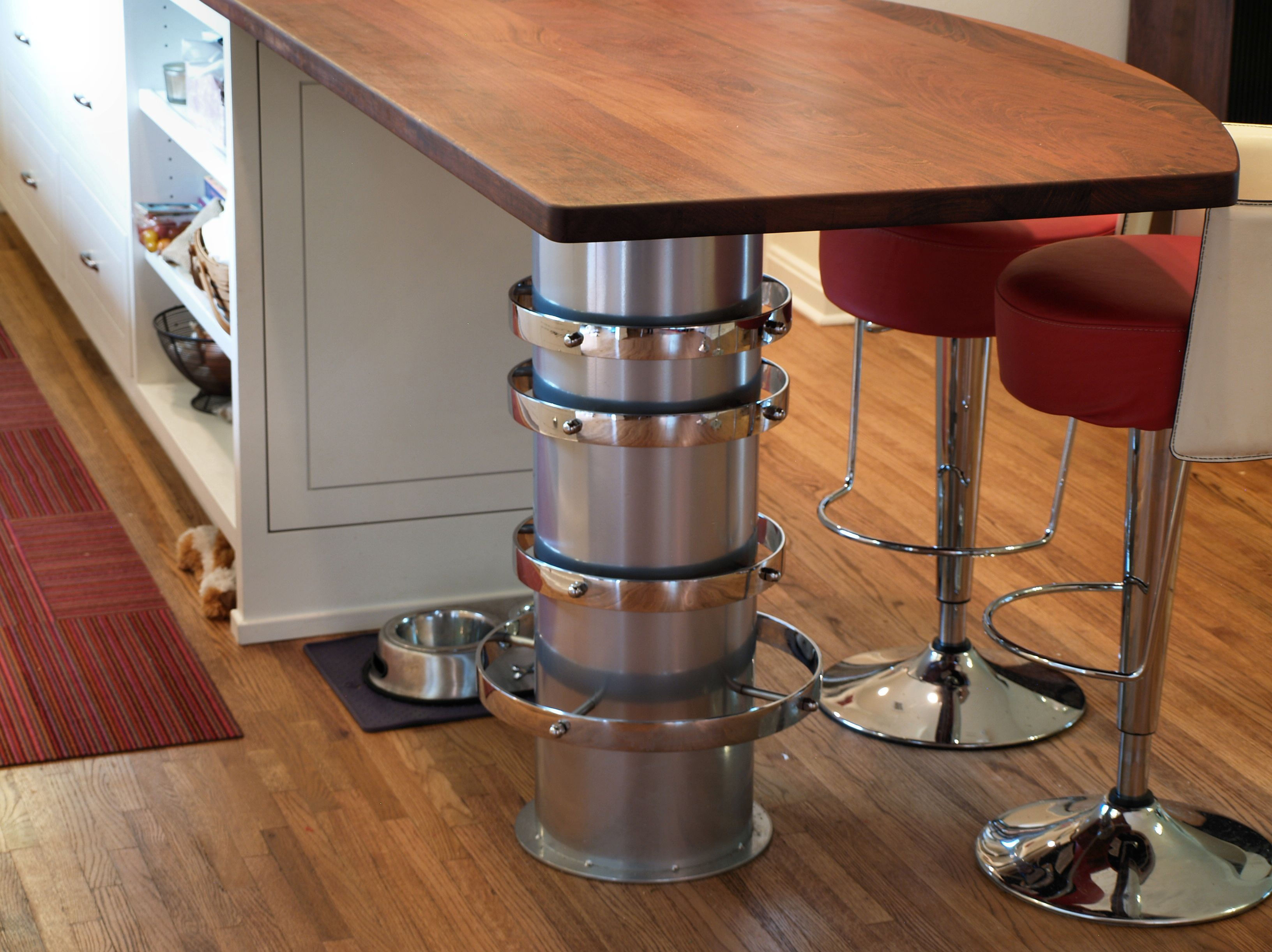 Jatoba face grain island countertop with Tung Oil Citrus finish.  Custom metal base designed by DeVos Custom Woodworking.