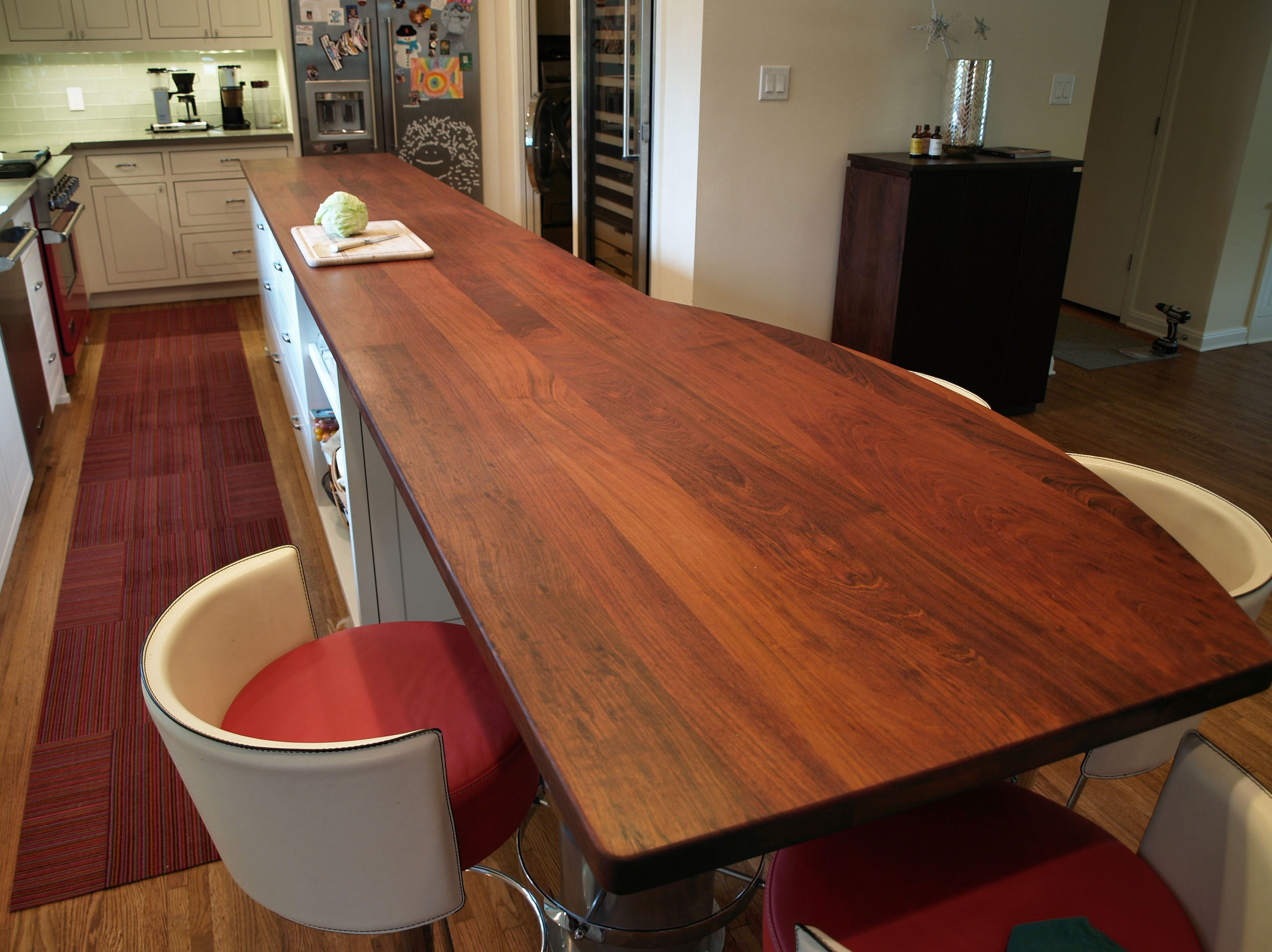 Jatoba face grain island countertop with Tung Oil Citrus finish.  Custom metal base designed by DeVos Custom Woodworking.