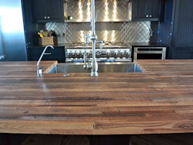 Reclaimed Boxcar Flooring edge grain wood island countertop with Tung-Oil finish.