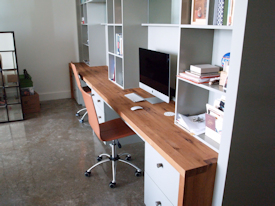 Reclaimed White Oak custom wood desk with DeVos Puzzle Joint along the length.  Finger Joint ends with Waterfall return to the floor and Tung-Oil finish.