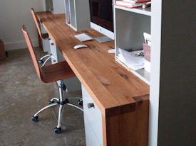 Reclaimed White Oak custom wood desk with DeVos Puzzle Joint along the length.  Finger Joint ends with Waterfall return to the floor and Tung-Oil finish.