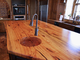 Texas Pecan book matched slab wood island top with Natural Edges and an integrated Texas Pecan Sink.  Waterlox Satin finish.