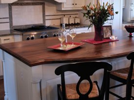 Walnut face grain wood island countertop.