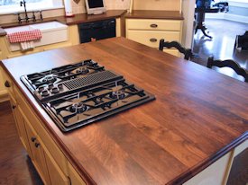 Walnut face grain wood island countertop.