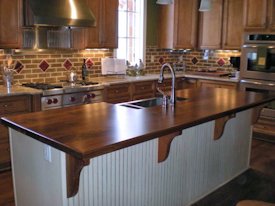 Walnut face grain island countertop with custom corbels.