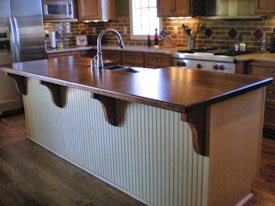 Walnut face grain island countertop with custom corbels.