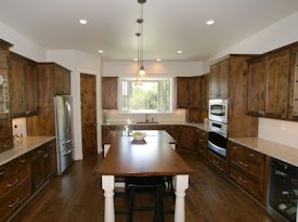 Walnut face grain island countertop with custom corbels.