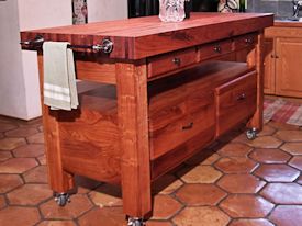 Custom mesquite chef's table with a 4 inch thick edge grain top, mortise and tenon jointery, and full extension drawers.