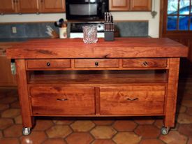 Custom mesquite chef's table with a 4 inch thick edge grain top, mortise and tenon jointery, and full extension drawers.