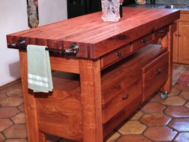 Custom mesquite chef's table with a 4 inch thick edge grain top, mortise and tenon jointery, and full extension drawers.