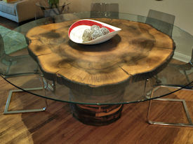Custom Pecan Button Slab table with an organic shaped base using stacked walut rings.  Tung-Oil finish