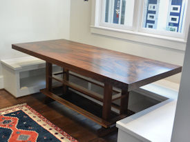 Custom Banquette Table.  Constructed using Slab Guanacaste with a Face Grain Walnut Band and a Custom Walnut Table Base.  Waterlox Satin Finish.