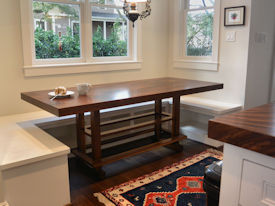 Custom Banquette Table.  Constructed using Slab Guanacaste with a Face Grain Walnut Band and a Custom Walnut Table Base.  Waterlox Satin Finish.