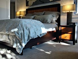 Custom Wenge and Cherry panel bed with matching night stands.