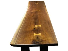 Custom hall table using a walnut slab top with inlaid hard maple butterfly accents and a custom flat black metal base. 