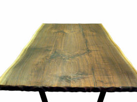 Custom Walnut Bookmatched Slab Table with Natural Edges, a Tung-Oil Finish and a flat black metal base. 