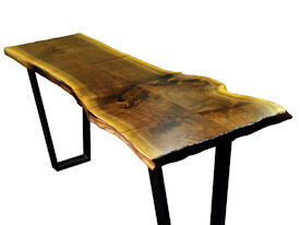 Custom Walnut Bookmatched Slab Table with Natural Edges, a Waterlox Finish and a flat black metal base. 