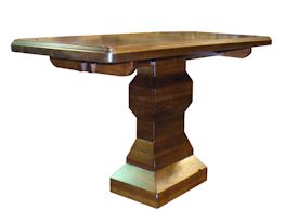 Custom distressed walnut table with pedestal-style base.