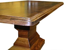 Custom distressed walnut table with pedestal-style base.