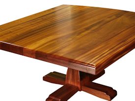 Custom jatoba table with pedestal-style base and drop-edge top.