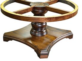 Custom round walnut table with turned pedestal-style base