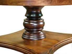 Custom round walnut table with turned pedestal-style base