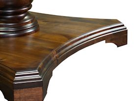 Custom round walnut table with turned pedestal-style base