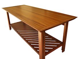 Custom Jatoba vanity table with carved top and slat-style shelf.